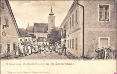 dobová pohlednice vsi s kostelem