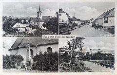 historická pohlednice vsi s kostelem (vlevo)