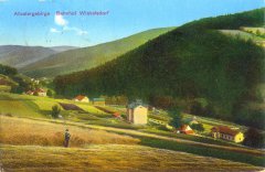 kaple na dobové pohlednici (budova s červenou střechou u stromu, vpravo od vysoké budovy uprostřed)