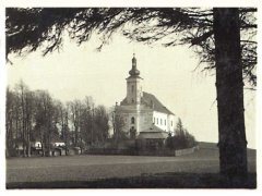 historické foto vikářství (uprostřed před kostelem), vlevo je hostinec, menší stavby v aleji jsou kramářské boudy stavěné v době procesí