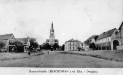 dobová pohlednice vsi s kostelem