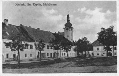 dobová pohlednice vsi s kostelem